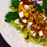 mediterranean zoodle salad with tomatoes, feta, and pine nuts