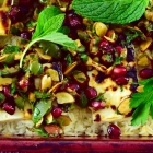 colorful baked rice with mint, feta and pomegranate